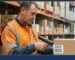 Cardboard food cases in a wholesale warehouse showing producer lot number and expiry date labels for EU traceability